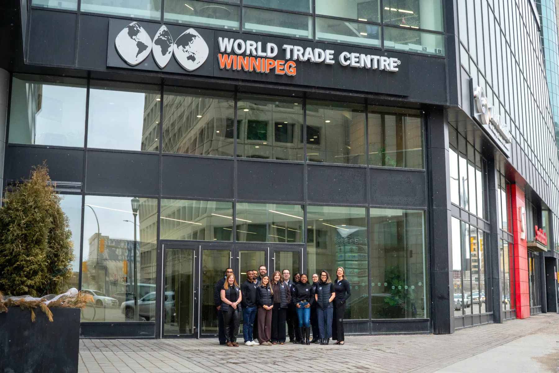 WTC Winnipeg team standing in front of the office on 200 Portage Avenue.