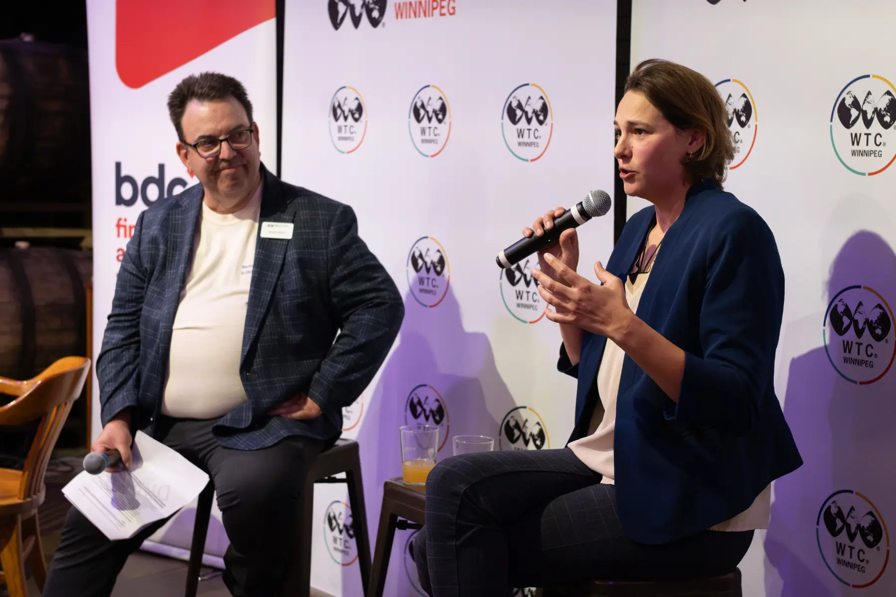Camila Bellon, CEO of Easton Automation speaking at a WTC Talks event, sharing the stage with André Brin, CEO of WTC Winnipeg.
